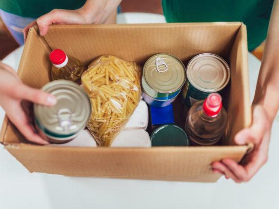 box of canned non-perishable food for donation istock